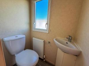 a bathroom with a toilet and a sink and a window at Lovely 6 Berth Caravan Nearby Hunstanton Beach In Norfolk Ref 23071T in Hunstanton +14 photos