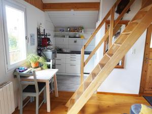 a kitchen with a wooden staircase in a tiny house at "Les Echalas" Chalet indépendant avec cuisine en Lavaux Unesco in Chexbres
