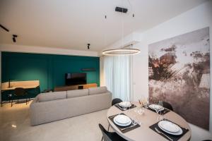 a living room with a table and a couch at Compagnoni Suite Luxe - Spa & Wellness in Milan