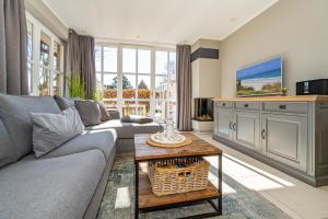 a living room with a couch and a table at Anker Hus in Westerland (Sylt) +32 photos