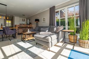 a living room with a couch and a table at Anker Hus in Westerland (Sylt)