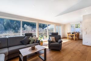 a living room with a couch and chairs and a table at Ferienhaus Wiese in Schmallenberg