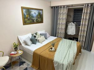 a small bedroom with a bed with a yellow blanket at Уютный уголок кв 54 in Shymkent
