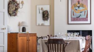 a dining room with a table with wine glasses on it at The Hill in Baldersby