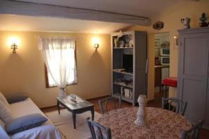 un salon avec une table et un canapé dans l'établissement Gîte une treille en provence, à Saint-Didier