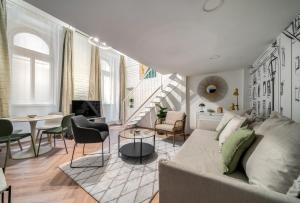 a living room with a couch and a table at Paulay at Opera Suites P39 in Budapest