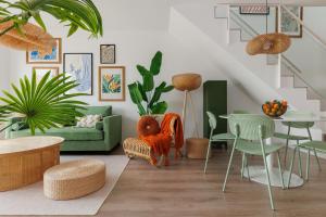 a living room with a green couch and chairs at way2sun penthouses Gran Alacant - FREE e-bikes & jacuzzi & solarium & PS5 in Gran Alacant