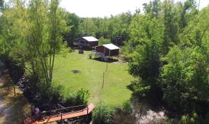 an aerial view of a cabin in a field with trees at Las Luciérnagas del Delta 1 in Tigre