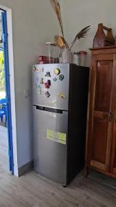 a refrigerator in a kitchen with magnets on it at Oasis Azul Paradise, Casa de Playa con Piscina in Las Uvas
