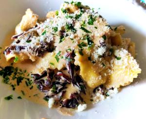 a piece of food on a white plate at BluBed Mare - Quadrupla Bagno Cucina e Balcone in San Giovanni Teatino +23 photos