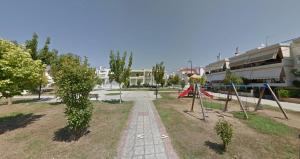 a park with a swing set and a playground at Charys Premium Home in Preveza