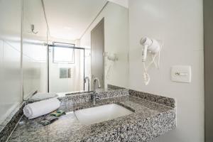 a bathroom with a sink and a shower at Uniclass Hotel Lapa in São Paulo +61 photos