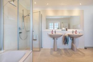 a bathroom with two sinks and a shower at Graf Rudolf in Burg +25 photos