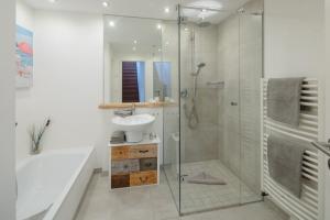 a bathroom with a glass shower and a sink at Ferienloft Inselliebe in Norderney +9 photos