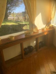 a wooden window sill with bowls on it next to a window at Croft cabin in Fort William