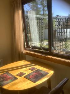 a wooden table in a room with a window at Croft cabin in Fort William +14 photos