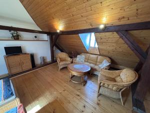 an attic living room with a couch and a table at Pension Parkan in Český Krumlov