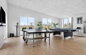 a room with two ping pong tables and two pool tables at Nice Home In Højslev With Sauna in Højslev