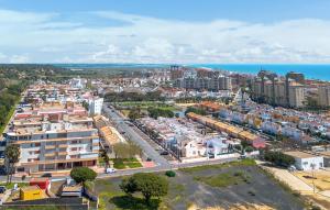 an aerial view of a city with buildings and the ocean at Awesome Home In Islantilla - Lepe in Islantilla