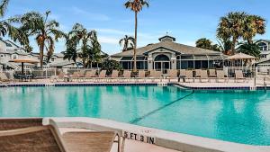 a large swimming pool with chairs and a building at Spacious 2BR condo on Siesta Key with private beach access in Siesta Key