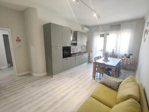 a living room with a couch and a table and a kitchen at Best Residence Termoli in Termoli