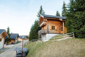 a wooden house on top of a hill at Feriendorf Koralpe Chalet Koralmkristall in St. Gertraud