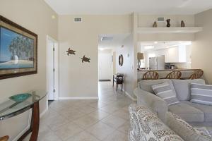 a living room with a couch and a table at Beach Access - Tennis - Two Pools - Fishing Dock in Siesta Key