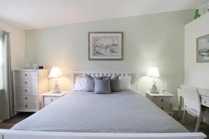 a bedroom with a large white bed with two night stands at Beach Access - Tennis - Two Pools - Fishing Dock in Siesta Key +34 photos