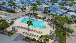 an aerial view of a swimming pool with palm trees and houses at Beach Access - Tennis - Two Pools - Fishing Dock in Siesta Key