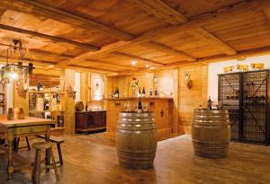 a large room with wooden walls and wooden floors with barrels at Berglodge Ristis in Engelberg