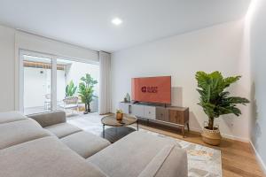 a living room with a couch and a flat screen tv at GuestReady - Vera Cruz Apartments in Porto