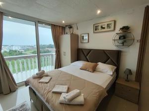 a bedroom with a large bed with a large window at Becic Apartments in Ulcinj