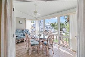 a living room with a table and chairs and a couch at Spacious 3BR Siesta Key condo with private beach access in Siesta Key