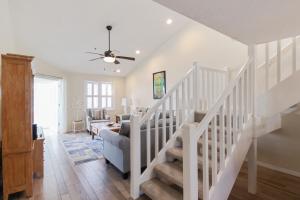 a white staircase in a living room with a ceiling fan at Spacious 3BR Siesta Key condo with private beach access in Siesta Key +44 photos