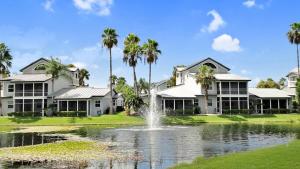 a house with a fountain in the middle of a pond at Spacious 3BR Siesta Key condo with private beach access in Siesta Key