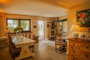 a kitchen and dining room with a table and chairs at Dom Wiejska 39 a in Ruciane-Nida