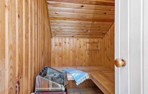 a sauna with a bench in a wooden room at Holiday Home Fanø 57 in Sønderho +10 photos