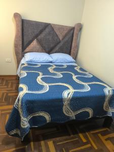 Rúm í herbergi á Hospedaje Wily Tacna