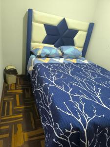 Rúm í herbergi á Hospedaje Wily Tacna