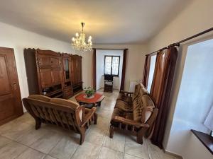 a living room with couches and a chandelier at Pension Parkan in Český Krumlov