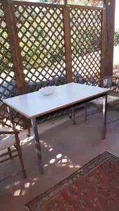 a white picnic table sitting on a patio at Palma House in La Massimina-Casal Lumbroso
