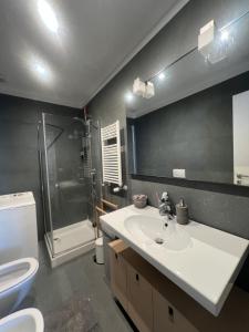 a bathroom with a sink and a toilet and a shower at La casa di Eli in Genoa +8 photos