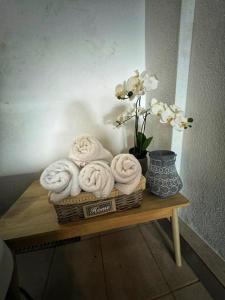 a basket of towels and a vase with flowers on a table at Luxury 2 storey 2bedroom condo with Private Jacuzzi & patio - Athens in Athens +44 photos