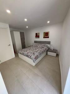 a bedroom with a bed and a tiled floor at Angel 29 in Vinarós