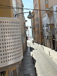 an empty street with buildings and a street light at Angel 29 in Vinarós