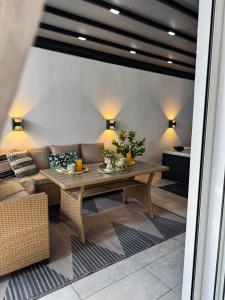 a living room with a table and a couch at Luxury 2 storey 2bedroom condo with Private Jacuzzi & patio - Athens in Athens