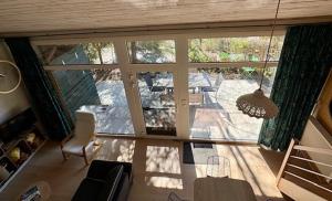 a view of a living room with a large window at Vieux Sart 34, chez Dame Béa in Stavelot +20 photos