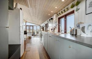a kitchen with white cabinets and a wooden ceiling at Stunning Home In Middelfart With Wifi in Middelfart