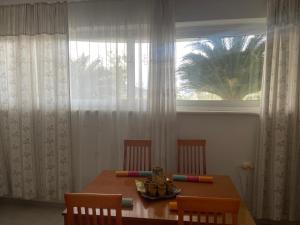 a dining room table with three chairs and a window at SeaView Ground in Elevtheraí