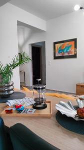 a wooden table with a tray with a candle on it at N&K Yellow Pearl Flat in Volos +6 photos